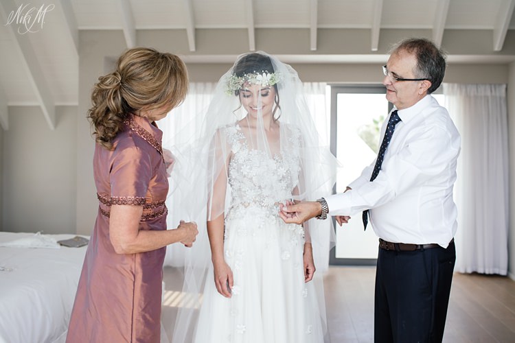 Bride spends time with her parents before departing the preparation venue