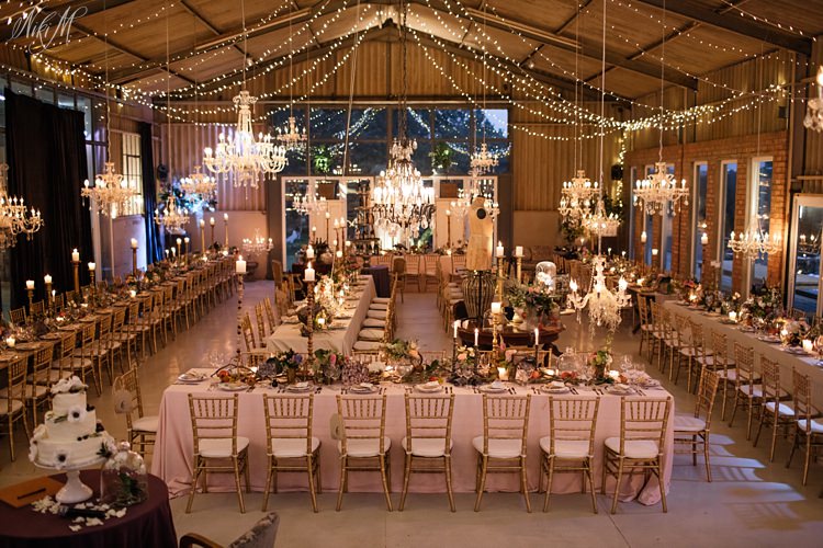 Otto de Jager Events Rose Barn Wedding moody evening reception decor with chandeliers and candlesOtto de Jager Events Rose Barn Wedding beautiful evening reception decor