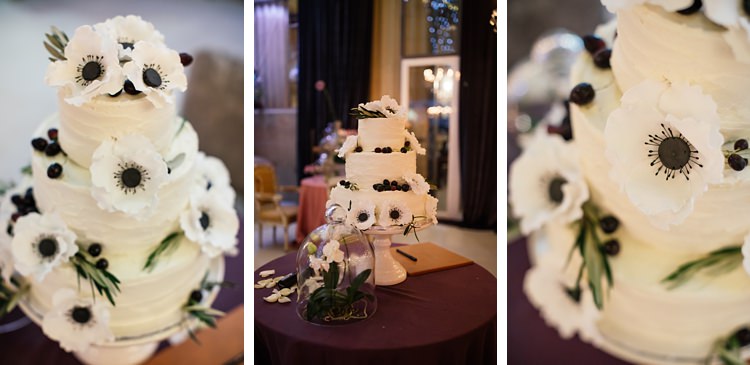 White wedding cake with iced anemone flowers and olives