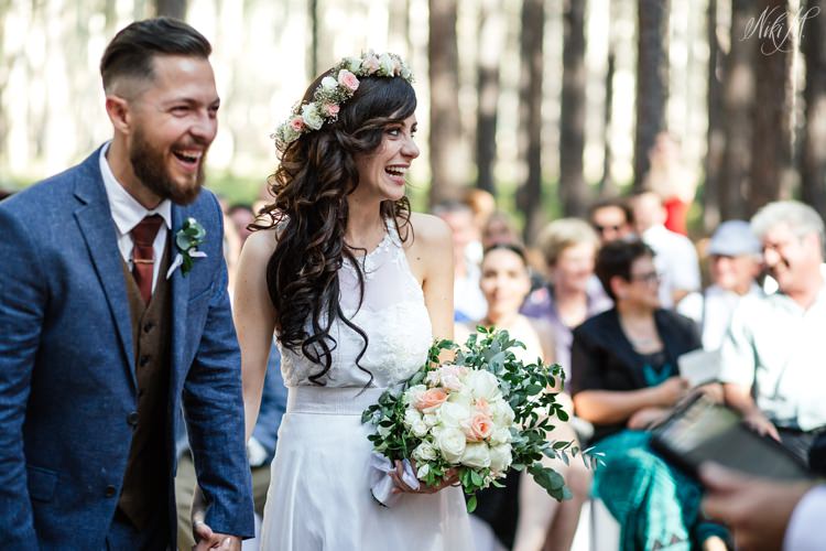 Amy and Silvino laugh during their wedding ceremony