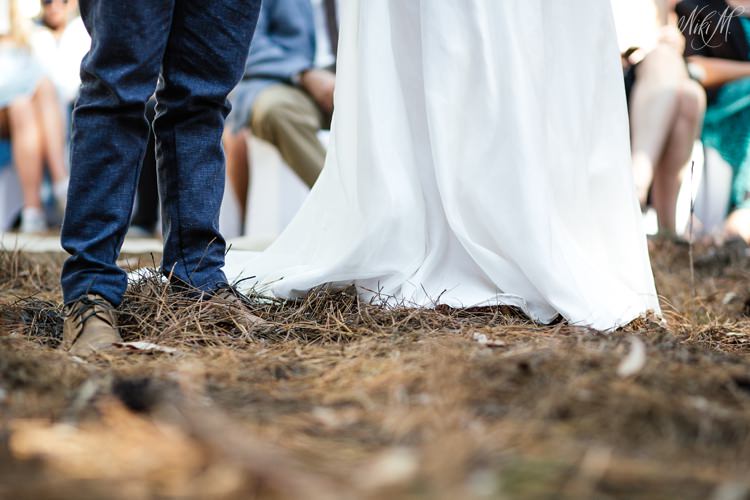 Image of the floor surrounding the bride and groom as they stand amongst pine needles