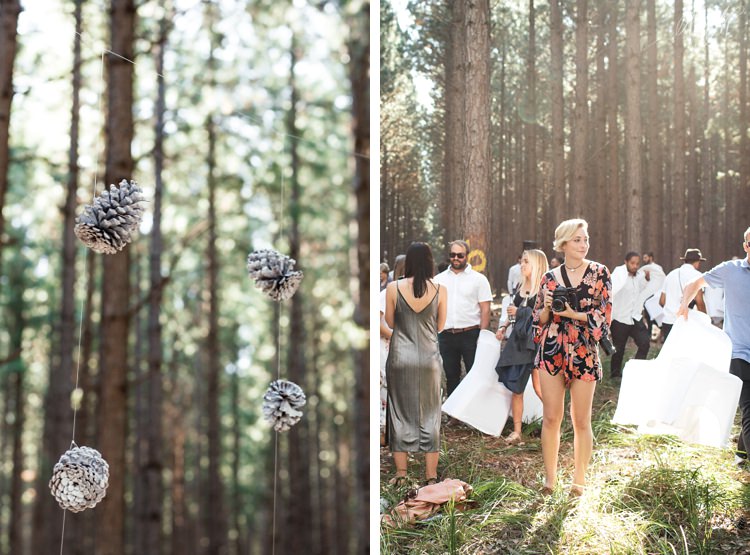 Pine cone details and wedding guests in the beautiful afternoon forest light
