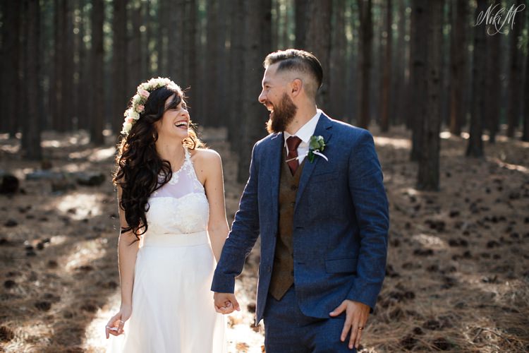 The bride and groom laugh as they move through the Tsitsikamma pine forest for their couple photos