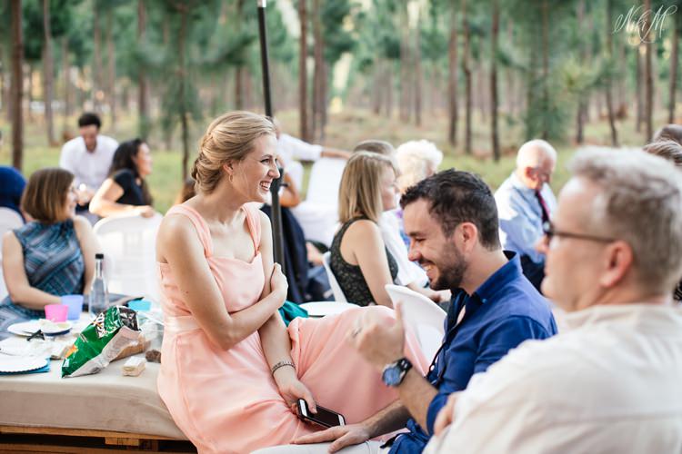 Guests listen to wedding speeches in the forest