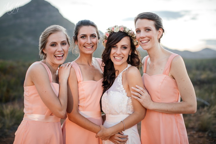 A portrait of the bride with her bridesmaids