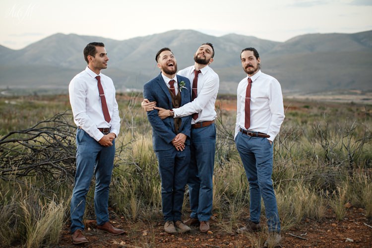 Silvino and his groomsmen with mountains behind them