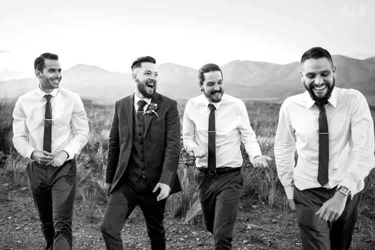 Groomsmen having fun and laughing whilst walking to the car