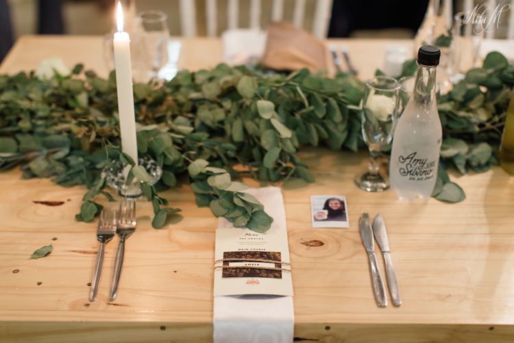 Simple and classic wedding decor at Assegaibosch in the Langkloof with a Eucalyptus leaf runner and custom printed water bottles