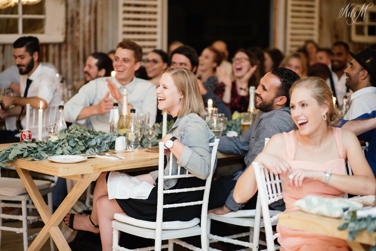 Wedding guests laugh during speeches