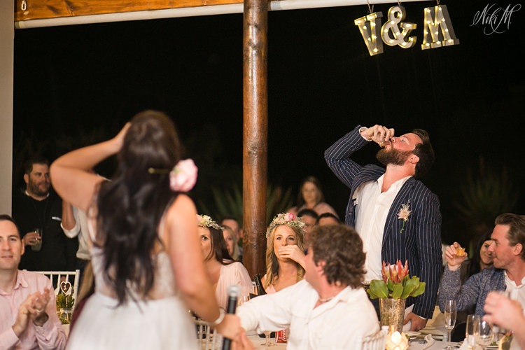 Bride and Groom share a tequila shooter at their wedding