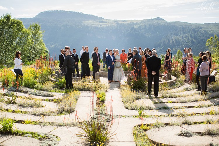 Bride and Groom are surrounded by friends and family inside the Labyrinth at Hogsback Wedding Venue, The Edge