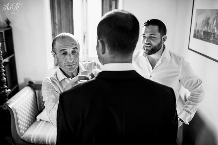 Groom prepares for his wedding in Tuscany wearing a custom tailored suit