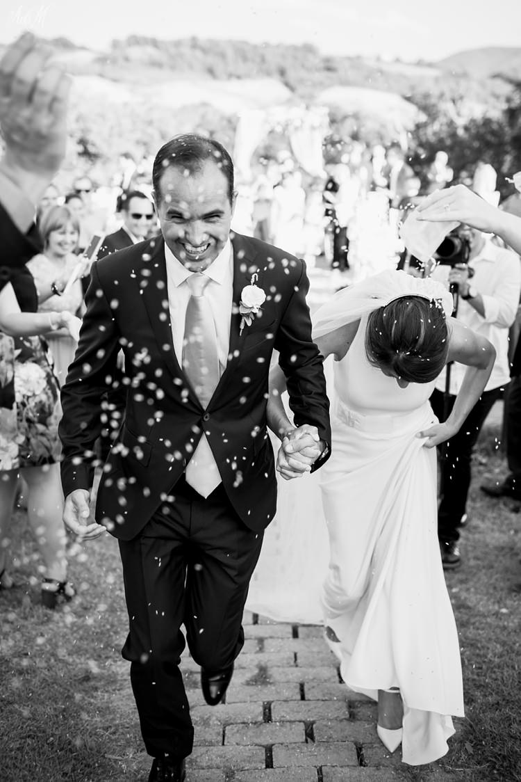 Bride and groom run through customary rice confetti in Italy