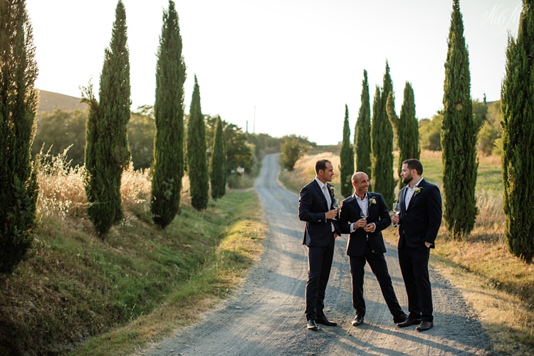 Groomsmen portraits on a winding road in Tuscany